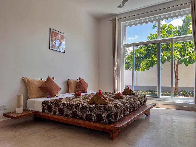 Aika House bedroom with garden-view windows, Mus Home Zanzibar