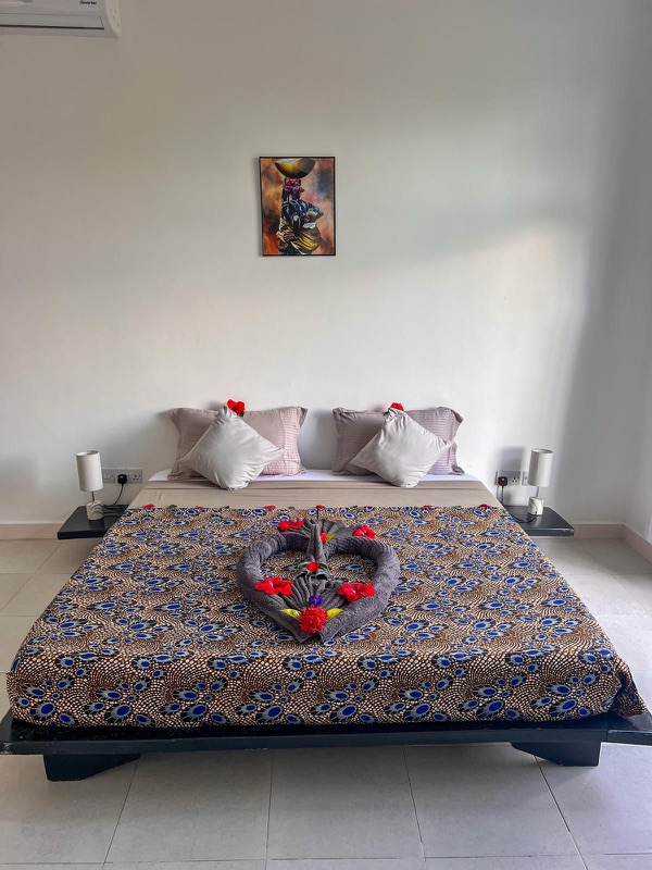 Ebende House bedroom with romantic honeymoon towel setup, Mus Home Zanzibar