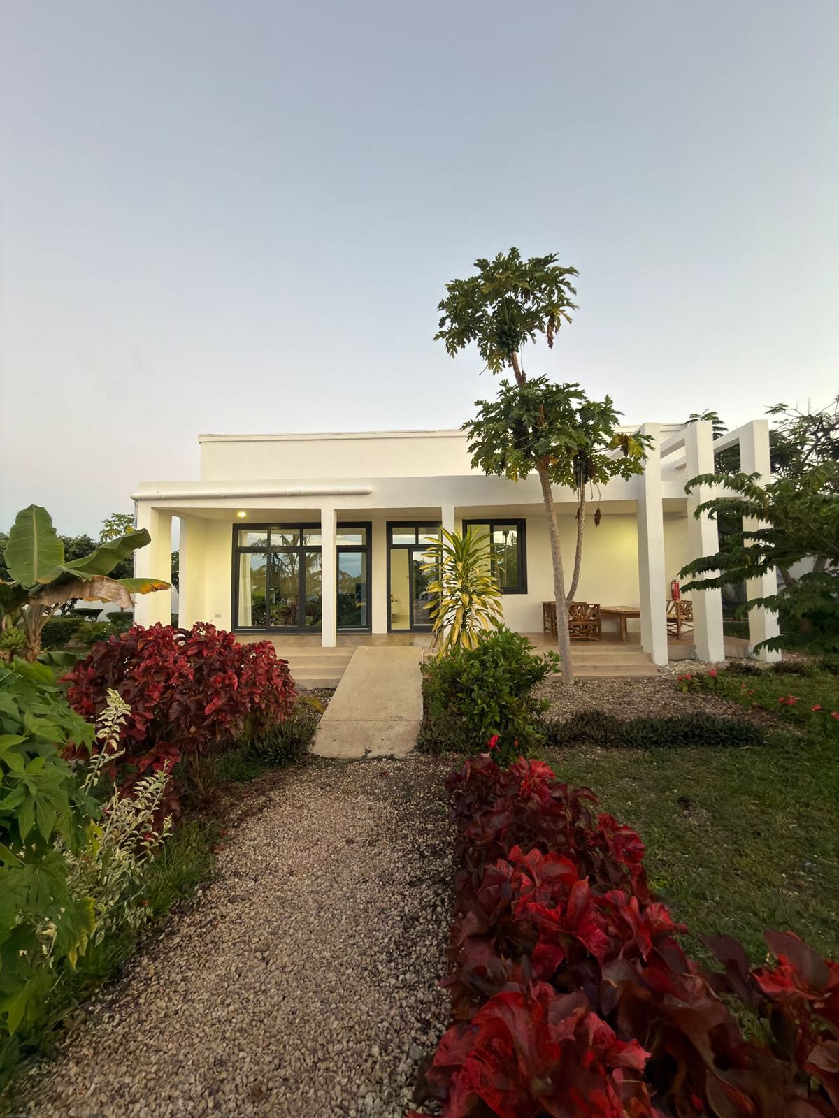 Villa exterior at twilight with garden lighting, Mus Home Zanzibar